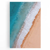 Stretched canvas wall art depicting a serene beach landscape at sunset, featuring vibrant colors of orange, pink, and blue, perfect for coastal-themed decor.