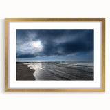 Framed wall art collection showcasing a serene beach landscape with soft golden hues and intricate matting, perfect for enhancing any living space.