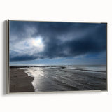 Framed canvas wall art showcasing a serene beach landscape in soft blue and beige tones, with a sleek silver frame, perfect for coastal decor enthusiasts.