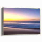 Framed canvas wall art showcasing a serene beach landscape design, featuring soft pastel colors and a silver frame, ideal for enhancing modern home decor.