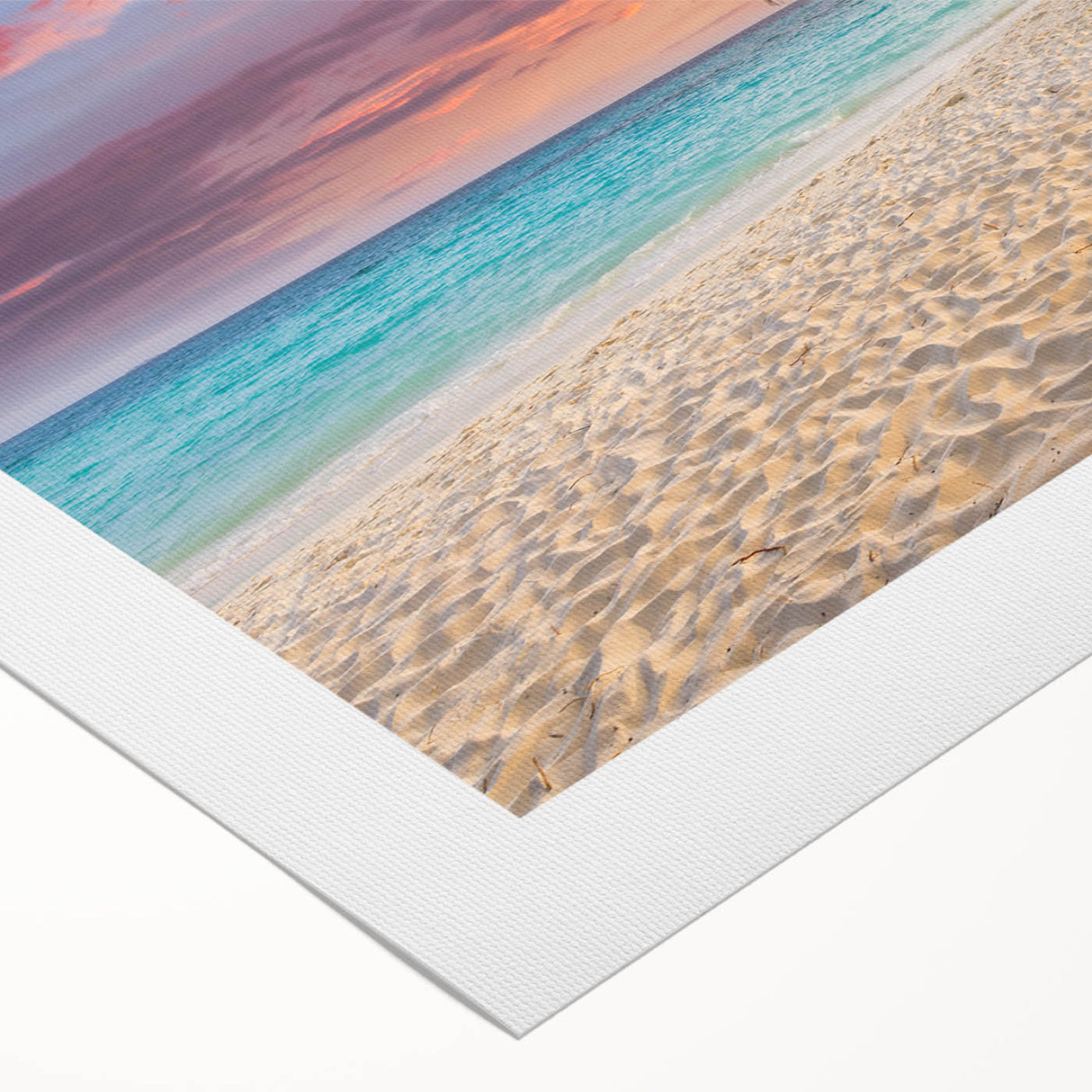 Vibrant rolled canvas wall art showcasing a serene beach landscape at sunset with gentle waves and colorful skies, ideal for home decor and relaxation.