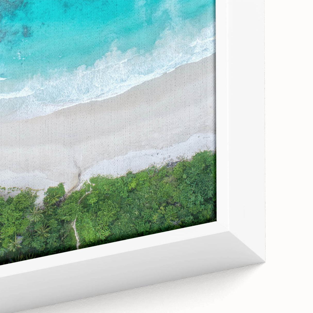 Close-up of a framed canvas wall art piece depicting a serene beach landscape, featuring vibrant colors and intricate details, perfect for home decor.