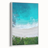 Framed canvas wall art showcasing a serene beach landscape with vibrant colors and waves, set against a white frame, ideal for modern decor.