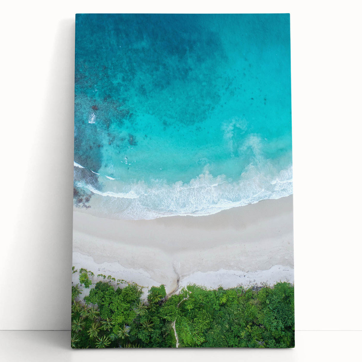 Stretched canvas wall art depicting a serene beach landscape with vibrant blue skies and golden sand, perfect for enhancing home decor and creating a tranquil atmosphere.