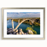 Framed wall art featuring a scenic landscape of a bridge, designed with a silver mat and frame, perfect for home decor and interior design enhancement.
