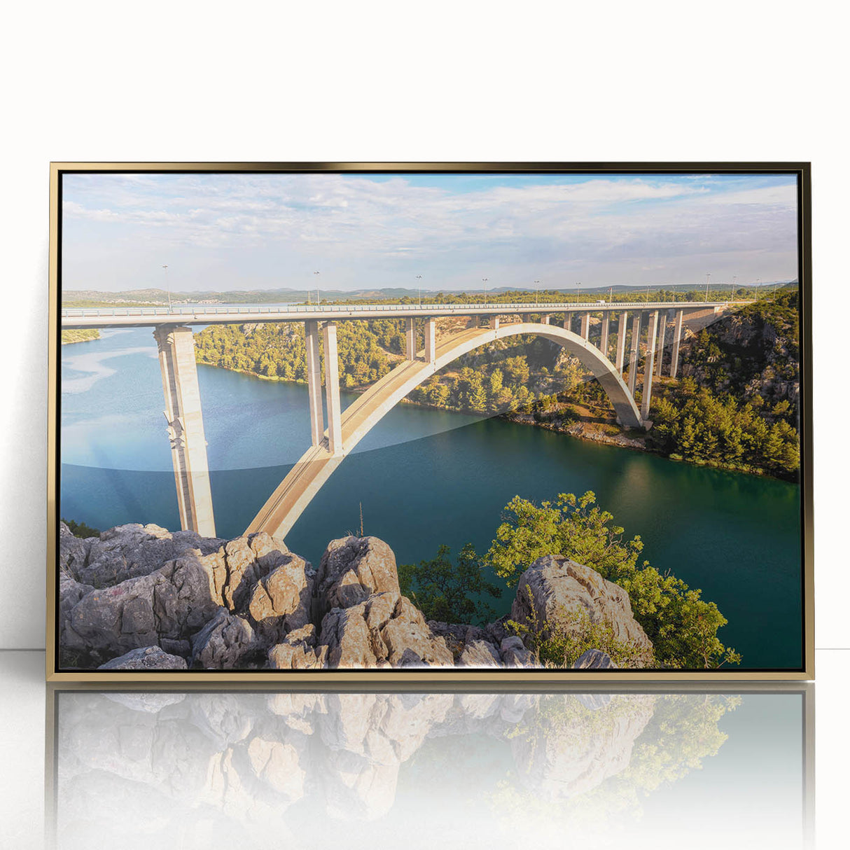 Framed acrylic wall art featuring a stunning landscape design with a bridge, highlighted by a gold frame, perfect for enhancing modern home decor.