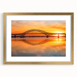 Framed wall art featuring a scenic landscape with a bridge, surrounded by a gold mat. Ideal for home decor, adding elegance and tranquility to any space.