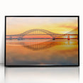 Framed acrylic wall art of a serene landscape featuring a bridge over a tranquil river, with vibrant colors and a sleek black frame, ideal for modern decor.