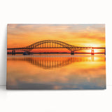 Stretched canvas wall art showcasing a vibrant landscape with a picturesque bridge, designed for home decor, leaning against a wooden wall.