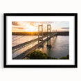 Framed wall art featuring a serene landscape with a bridge, presented in a sleek black frame with a mat. Ideal for enhancing home decor with an elegant touch.