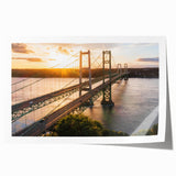 Rolled print featuring a vibrant landscape bridge design, showcasing lush greenery and a serene river beneath a clear blue sky, perfect for home décor.