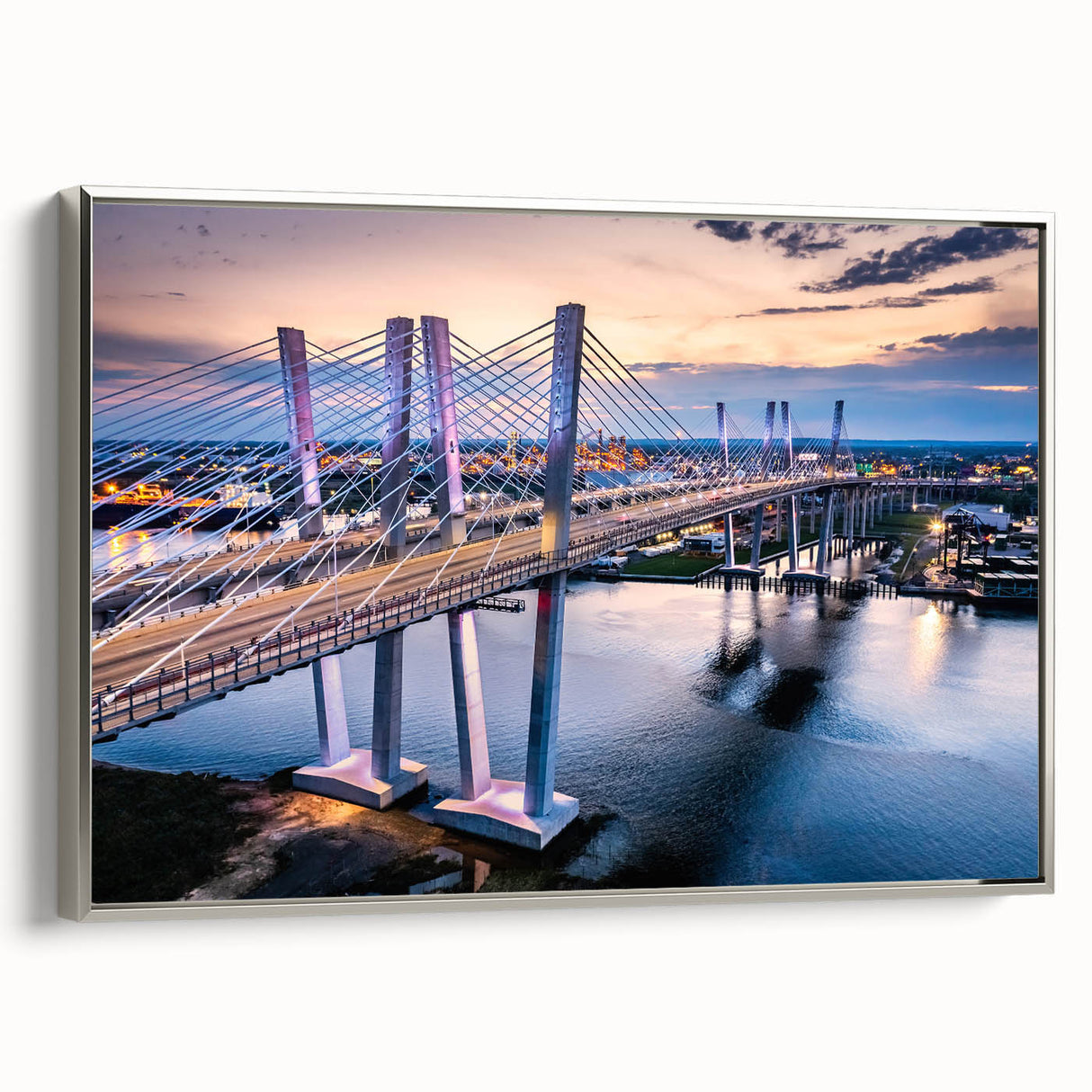 Framed canvas wall art featuring a serene landscape with a modern bridge design, showcased in a sleek silver frame, ideal for home or office decor.