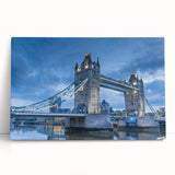 Stretched canvas wall art depicting a serene landscape scene featuring a vibrant sunset over a bridge, designed to enhance home decor with its warm colors and tranquil imagery.