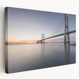 Stretched canvas wall art featuring a serene landscape with a wooden bridge, vibrant greenery, and soft blue skies, perfect for enhancing home decor and creating a tranquil atmosphere.