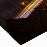 Close-up of a stretched canvas artwork depicting a serene landscape with a bridge surrounded by lush greenery, ideal for home decor and interior design enhancement.