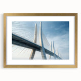 Framed wall art showcasing a serene landscape with a bridge, featuring a gold mat and elegant frame, perfect for enhancing home decor with a touch of nature.