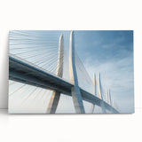 Stretched canvas wall art showcasing a serene landscape with a bridge over a calm river, featuring vibrant greens and blues, perfect for home decor.