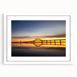 Framed wall art featuring a scenic landscape with a bridge design, set in a white mat and frame, perfect for modern home decor and enhancing interior aesthetics.