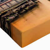 Close-up of a stretched canvas wall art piece showcasing a vibrant landscape with a bridge, featuring rich colors and intricate details, ideal for home decor.