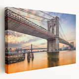 Stretched canvas wall art depicting a serene landscape with a bridge over a tranquil river, showcasing vibrant colors and natural beauty, perfect for home decor.