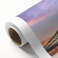 Rolled canvas artwork showcasing a vibrant landscape with a picturesque bridge, featuring rich colors and intricate details, perfect for home decor enhancement.