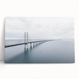 Stretched canvas wall art featuring a serene landscape with a bridge over a tranquil river, showcasing vibrant colors and intricate details, perfect for home decor.
