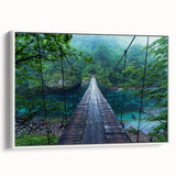 Framed canvas wall art showcasing a serene landscape with a bridge over water, featuring soft blue and green tones. Ideal for home decor, enhancing tranquility.
