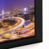 Framed canvas artwork showcasing a vibrant landscape with a bridge, featuring lush greenery and a serene river under a clear blue sky, perfect for home decor.