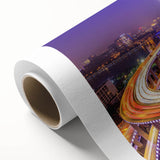 Rolled canvas artwork showcasing a serene landscape with a bridge over a tranquil river, featuring vibrant colors and intricate details, ideal for home decor.