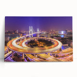 Stretched canvas art featuring a serene landscape with a modern bridge over a tranquil river, complemented by lush green trees and a clear blue sky. This wall art adds a calming touch to any contemporary decor.