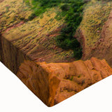 Close-up of a stretched canvas wall art piece showcasing a vibrant landscape of canyons, featuring rich earthy tones and intricate textures that evoke natural beauty. Perfect for enhancing home decor with a touch of nature-inspired elegance.