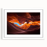 Framed artwork showcasing a vibrant canyon landscape in shades of orange and red, with a white mat and frame, perfect for modern home decor. Ideal for nature enthusiasts.