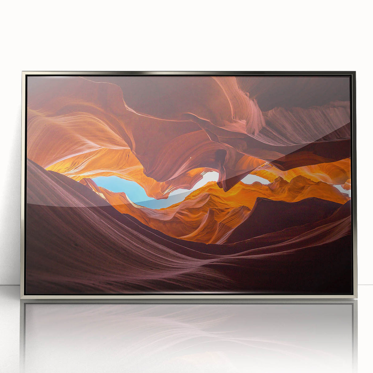 Framed wall art featuring an abstract canyon landscape design in vibrant colors, showcased in a sleek silver frame, ideal for modern home decor. This piece adds a touch of nature-inspired elegance to any space.