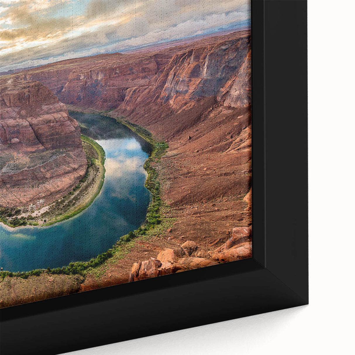 Close-up of a framed canvas print showcasing a vibrant desert canyon landscape, featuring rich reds and oranges, perfect for modern home decor.