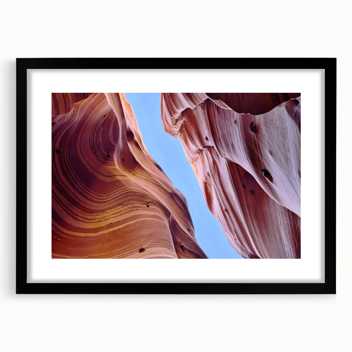 Framed wall art showcasing a stunning canyon landscape with vibrant colors, set in a sleek black frame and white mat, ideal for home decor and nature enthusiasts.