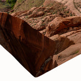 Close-up of a stretched canvas print showcasing a vibrant canyon landscape with rich earthy tones and intricate details, perfect for home decor enhancement.