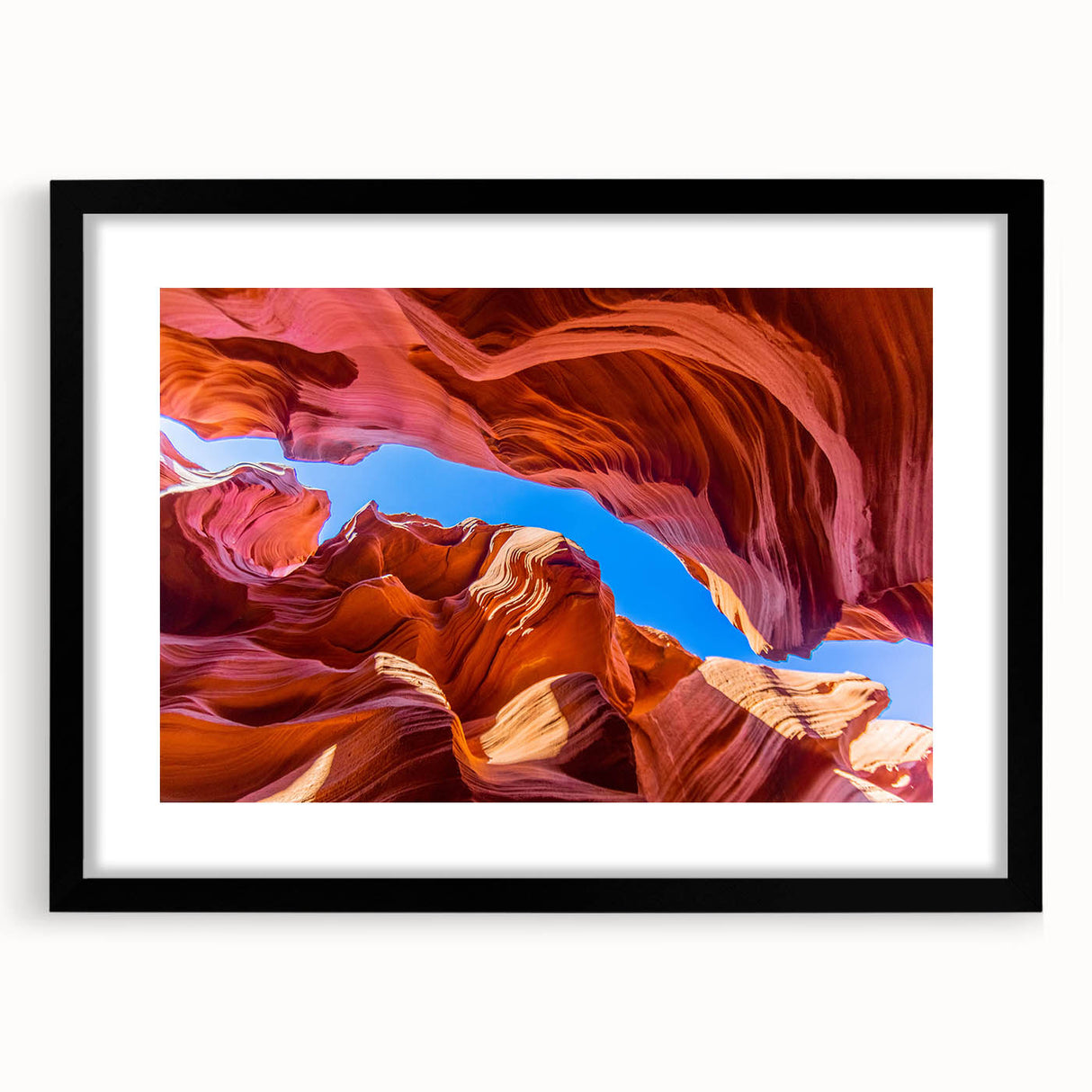 Framed wall art featuring a stunning landscape of canyons, presented in a sleek black frame with a mat, perfect for enhancing home décor. The artwork showcases vibrant colors and intricate details, ideal for nature lovers and modern interior design.