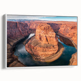 Framed canvas wall art showcasing a vibrant canyon landscape design with earthy tones, set against a white background, ideal for home decor enhancement.
