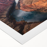 Sunset over rugged canyons captured in a rolled canvas wall art piece, featuring warm colors and dramatic textures, ideal for modern home decor.