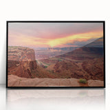 Framed wall art showcasing a vibrant canyon landscape design, featuring deep reds and oranges, with a sleek black frame, ideal for modern home decor.
