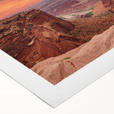 Stunning rolled canvas artwork showcasing a vibrant desert canyon landscape, featuring rich reds and oranges, perfect for home decor or gallery display.