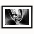 Framed wall art of a vibrant canyon landscape, featuring earthy tones and intricate details, showcased in a sleek black frame with a white mat.