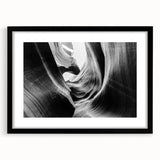 Framed wall art of a vibrant canyon landscape, featuring earthy tones and intricate details, showcased in a sleek black frame with a white mat.
