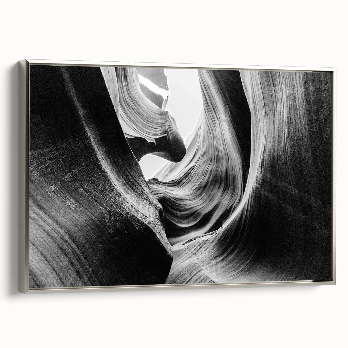 Framed canvas wall art showcasing a stunning canyon landscape with vibrant colors, featuring a silver frame that enhances the artwork's depth and elegance. Ideal for home decor enthusiasts looking to add a touch of nature-inspired beauty to their space.