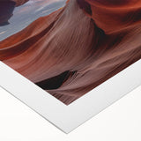 Vivid rolled canvas wall art showcasing a stunning desert canyon landscape in warm hues, perfect for home decor, packaged in a protective cardboard tube.