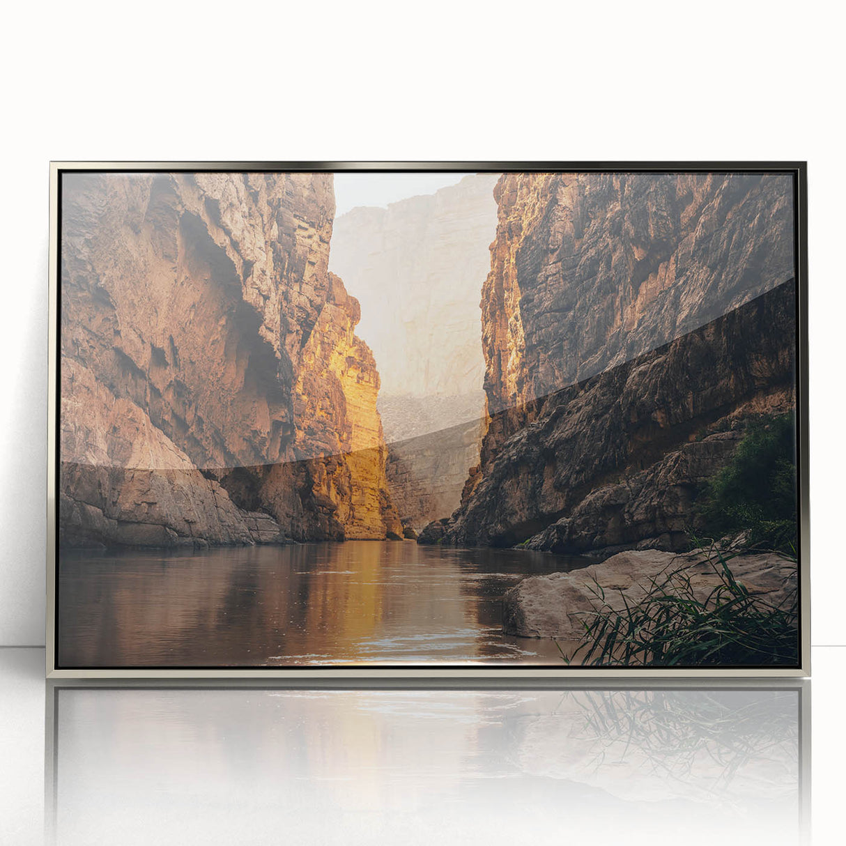 Framed acrylic wall art showcasing a stunning canyon landscape design with intricate details, presented in a sleek silver frame, ideal for enhancing modern interior decor.