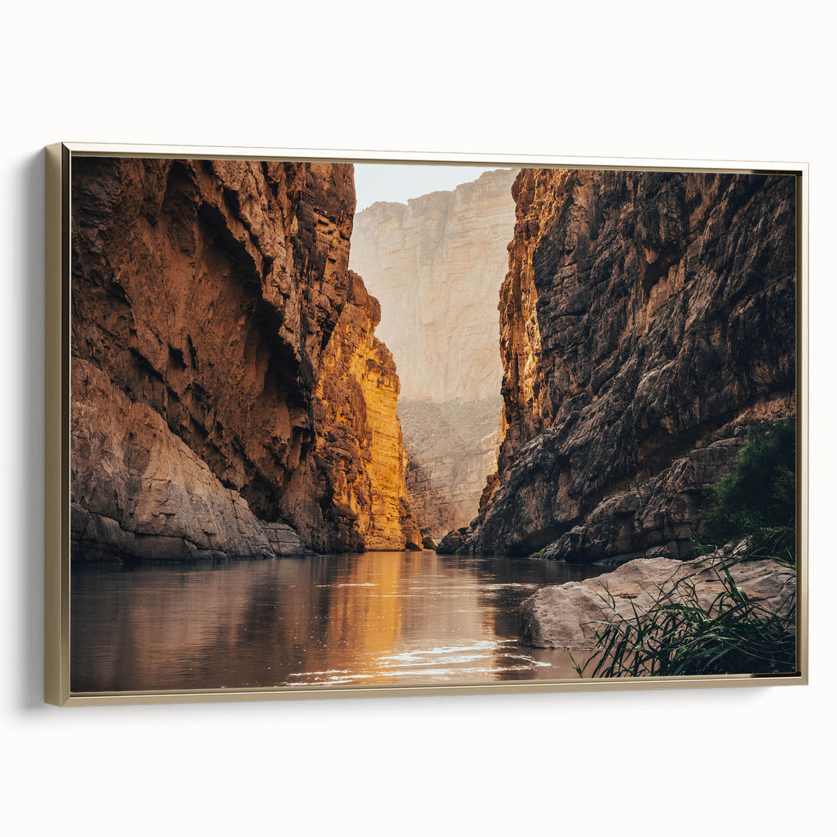 Framed canvas wall art featuring a stunning landscape of canyons in earthy tones, accented with a gold frame, ideal for modern home decor or office spaces.
