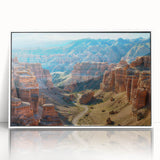 Framed acrylic wall art of a canyon landscape, featuring vibrant colors and intricate details, presented in a sleek white frame, ideal for modern home decor.