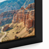 Framed canvas artwork showcasing a vibrant landscape of canyons in rich earth tones, emphasizing intricate details and textures, ideal for home decor enthusiasts.