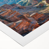 Vibrant rolled canvas artwork showcasing an abstract canyon landscape with rich earthy tones, perfect for home decor, presented in a protective cardboard tube.